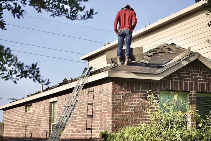 Professional roofer working on a residential roof in Neshaminy Woods